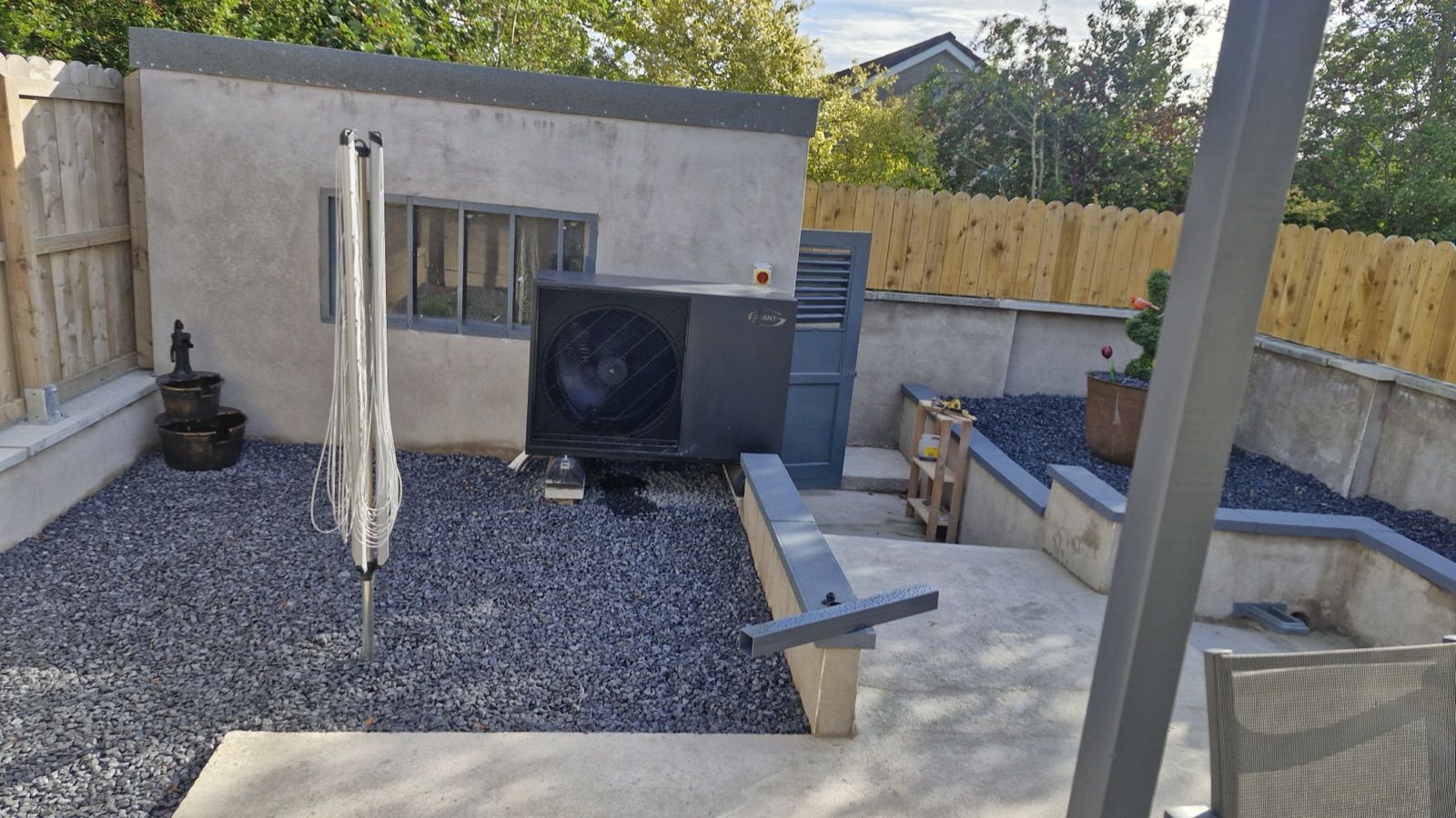 Air to water heat pump installed in a landscaped garden