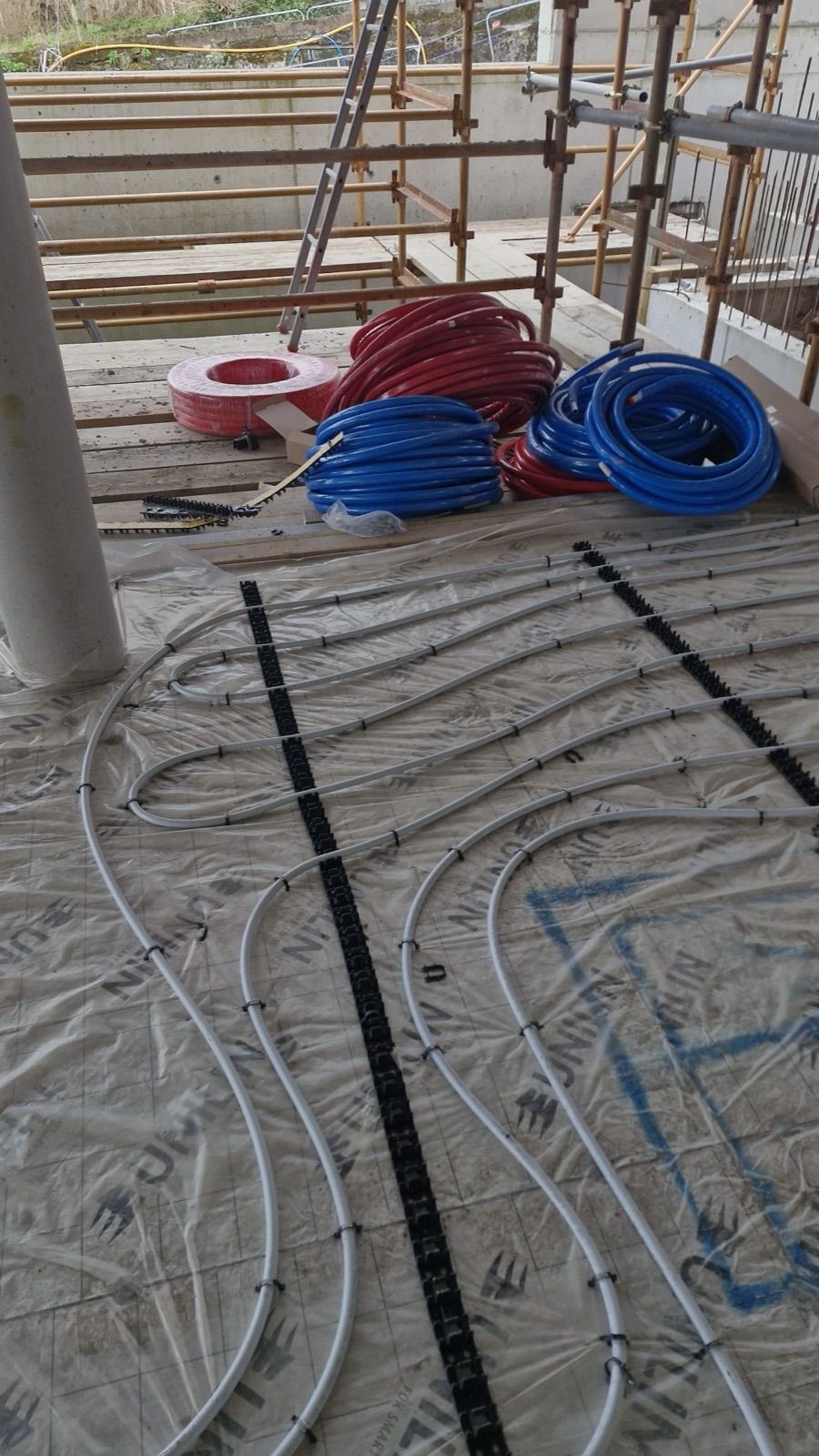 Underfloor heating pipe loops laid on a new build floor